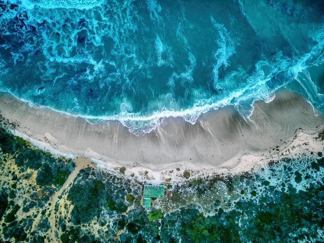View of a beach by the ocean from the air