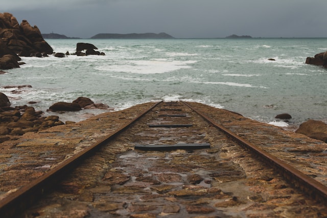 Old train tracks leading into the sea