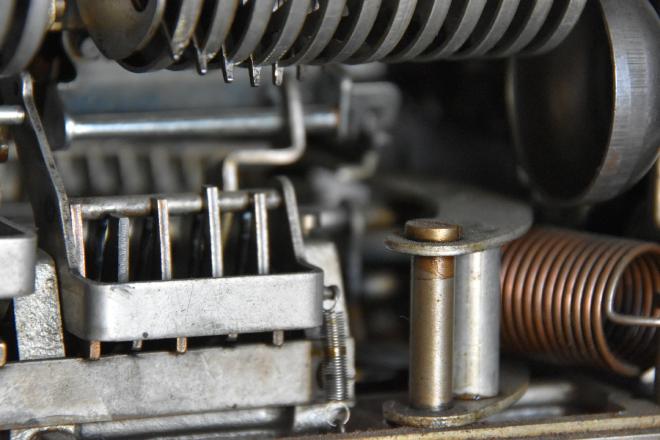 Metal pieces and springs inside some kind of machine