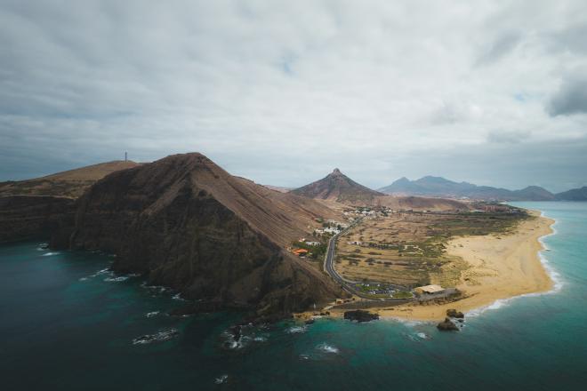 High altitude view of an island with mountains and a beach